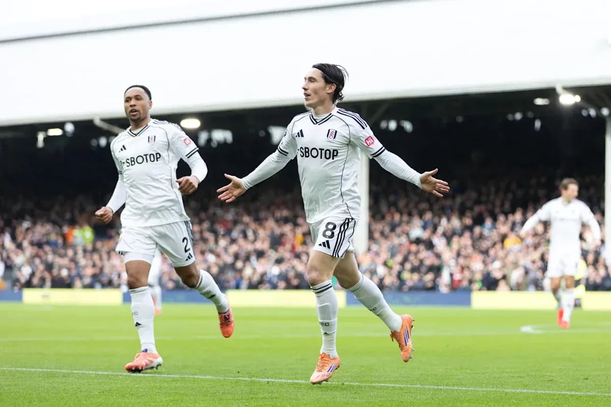 Fulham players celebrating a goal on the field Fulham players celebrating a goal on the field