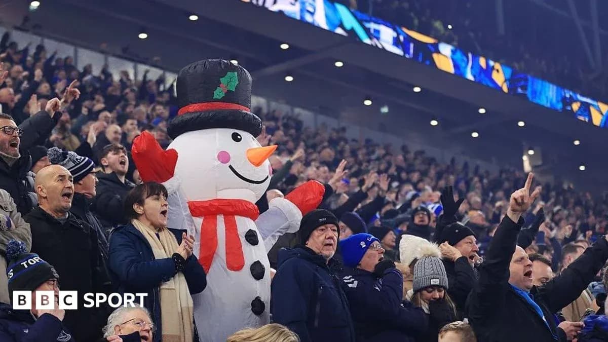 Fans cheering with a large inflatable snowman Fans cheering with a large inflatable snowman
