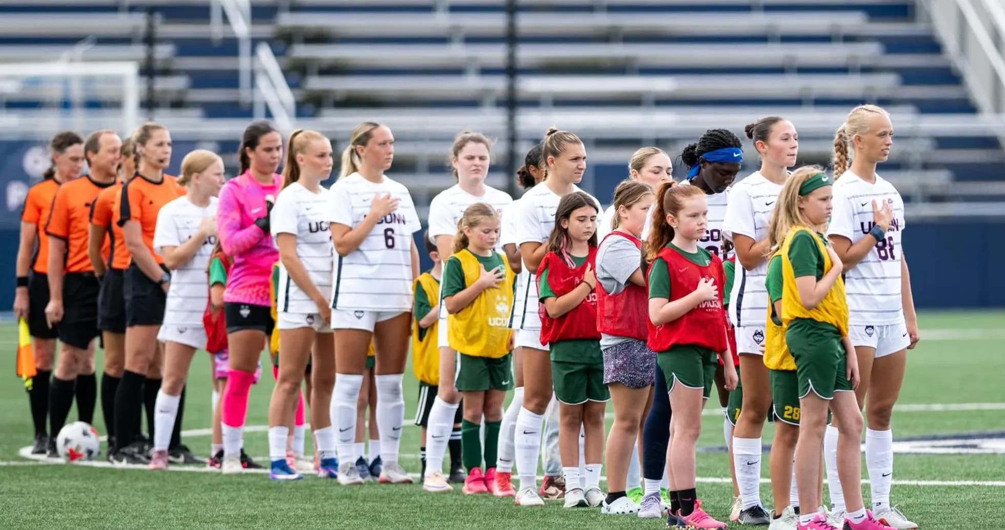 UConn soccer team and youth players during national anthem UConn soccer team and youth players during national anthem