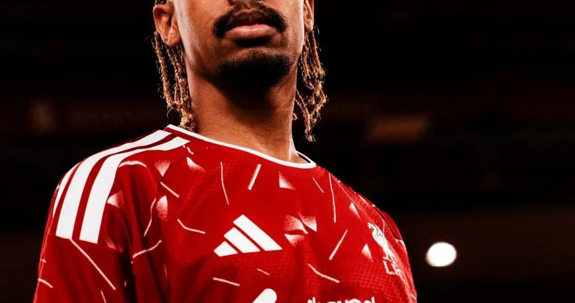 Player posing in red football kit with logo Player posing in red football kit with logo