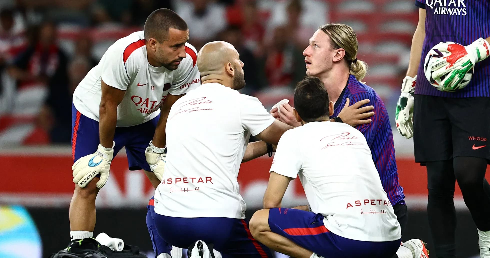 Medical staff attending to injured player on field Medical staff attending to injured player on field