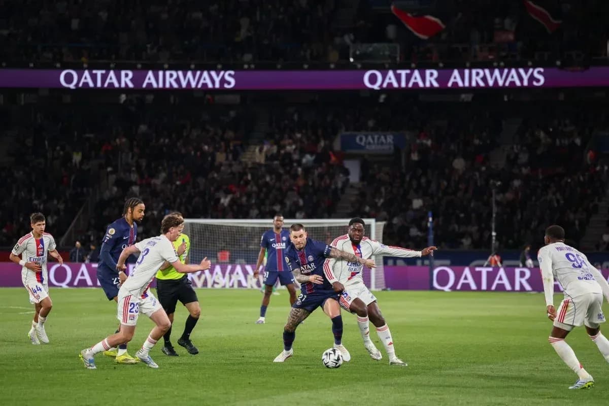 Players competing for the ball during PSG match Players competing for the ball during PSG match