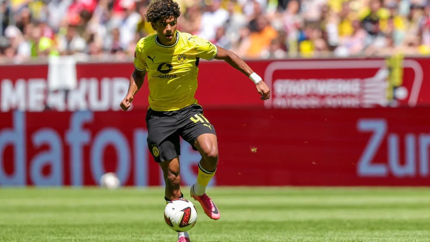 Player in yellow jersey dribbling the ball on field Player in yellow jersey dribbling the ball on field