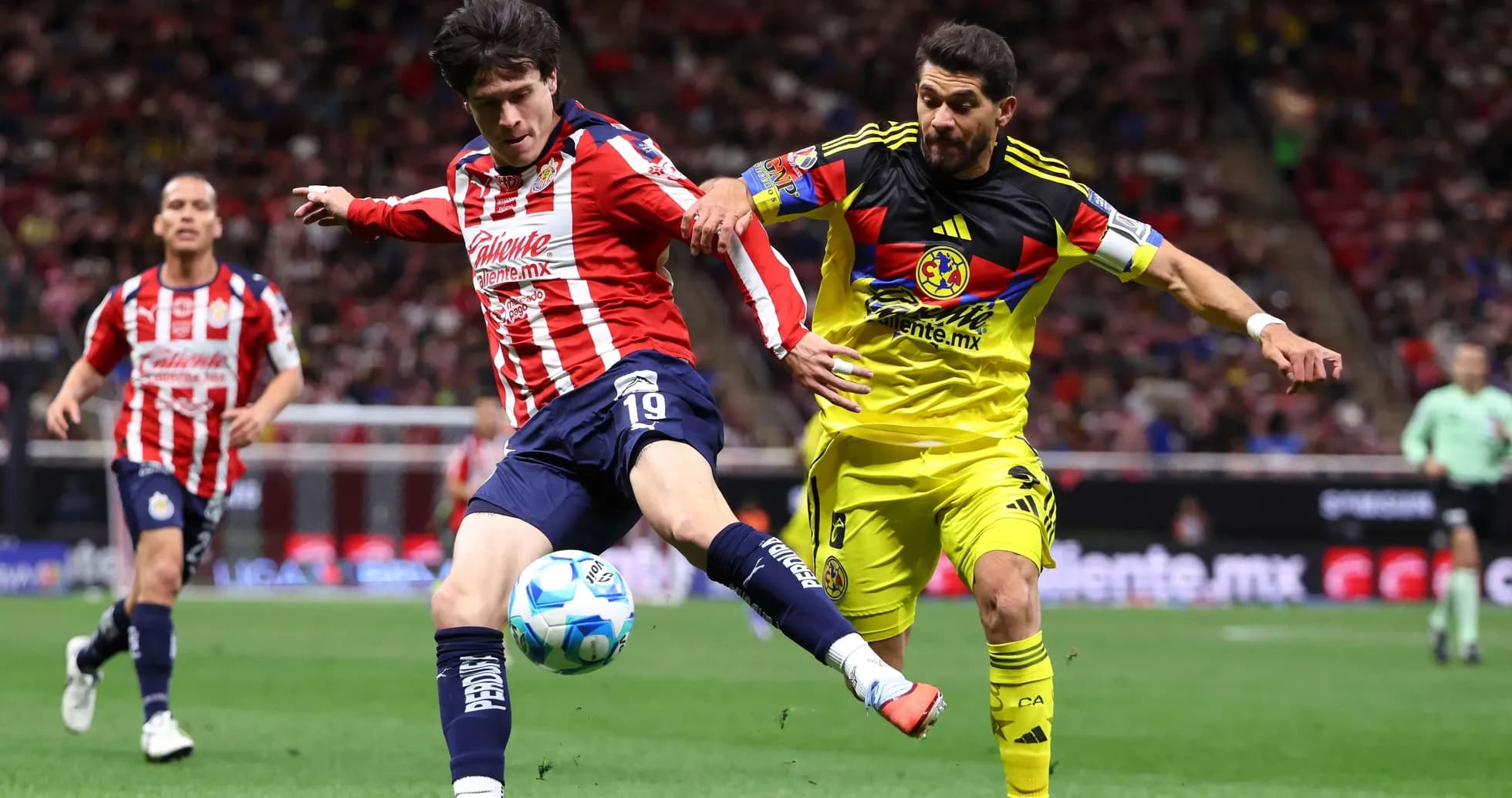 Club America player challenges Chivas player for the ball Club America player challenges Chivas player for the ball