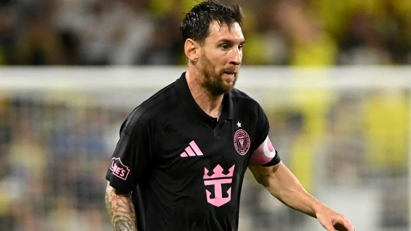 Player in black jersey running during match Player in black jersey running during match