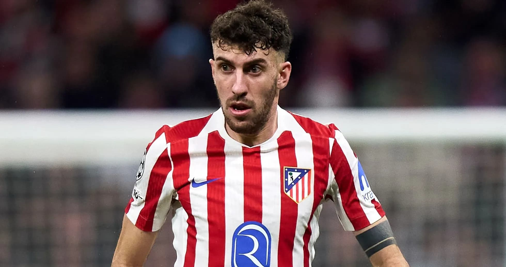 Atletico Madrid player in red and white striped jersey Atletico Madrid player in red and white striped jersey