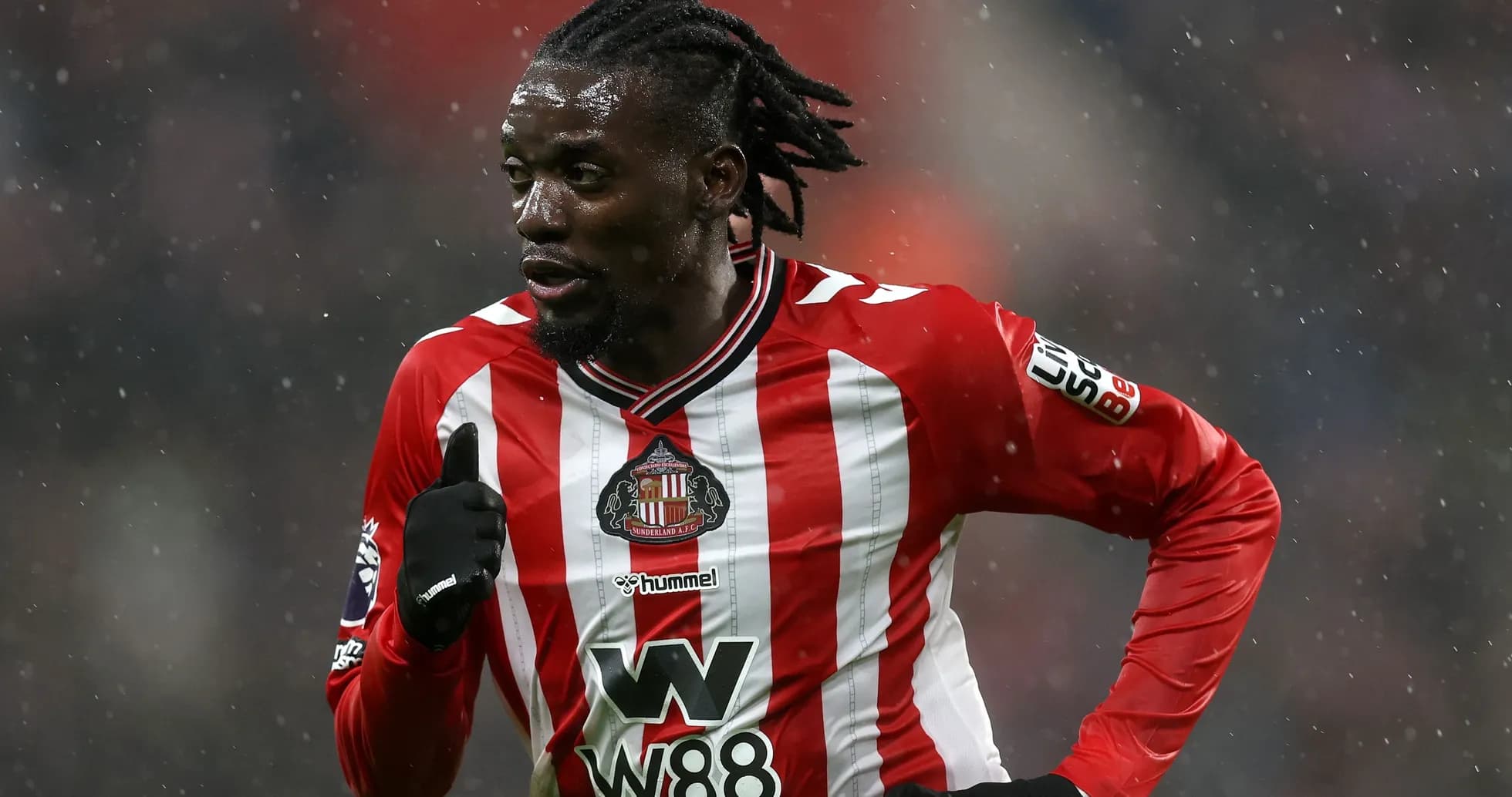 Sunderland player running during a snowy match Sunderland player running during a snowy match