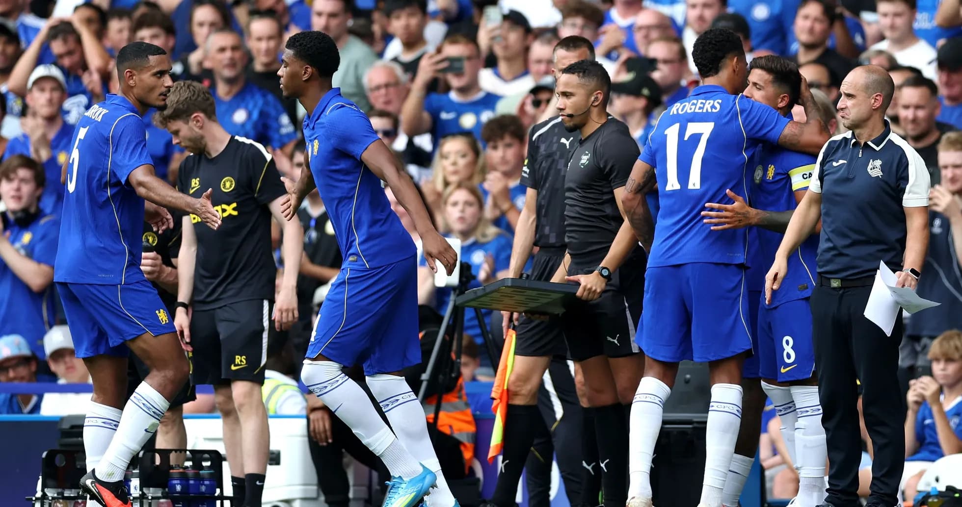 Players greeting each other during substitution on field Players greeting each other during substitution on field