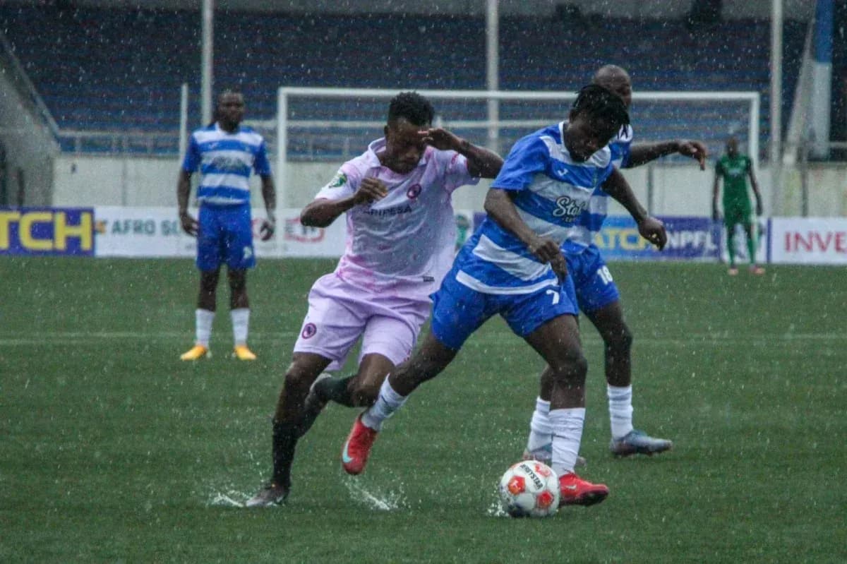 Enyimba player tackling Sporting Lagos opponent Enyimba player tackling Sporting Lagos opponent