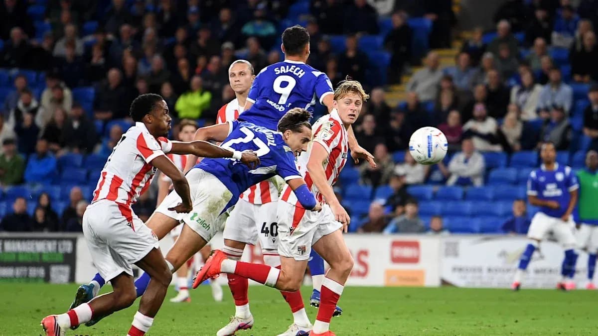 Player attempting a header during a football match Player attempting a header during a football match