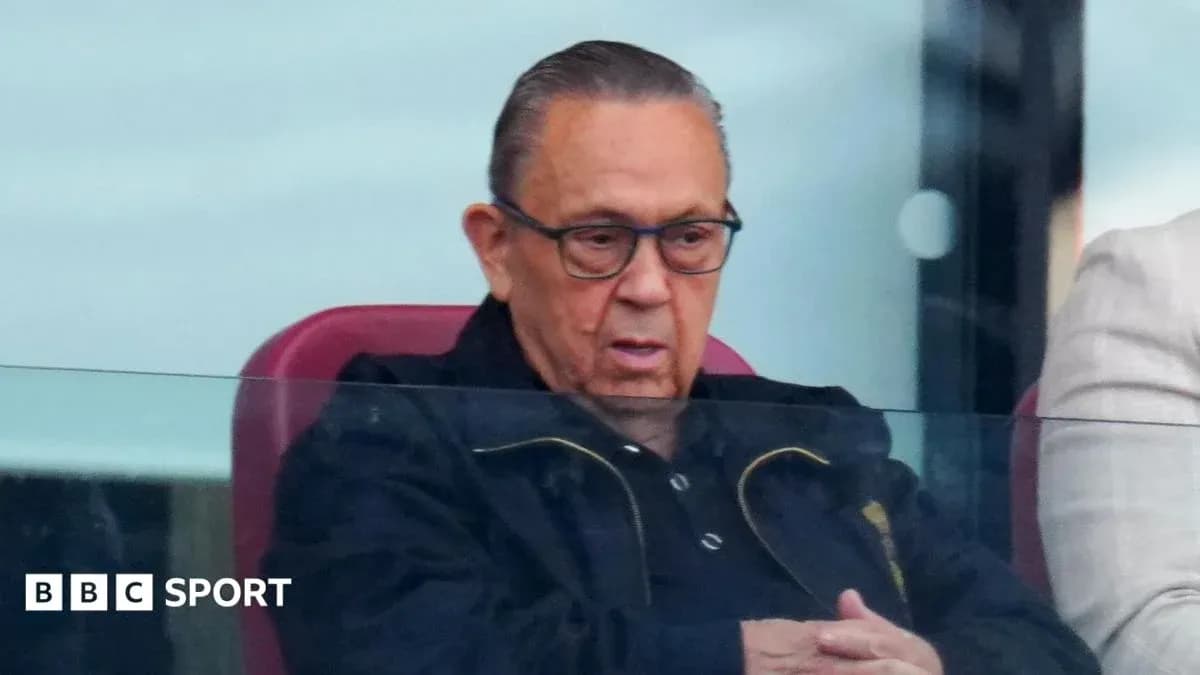 Man in glasses watching match from VIP box Man in glasses watching match from VIP box