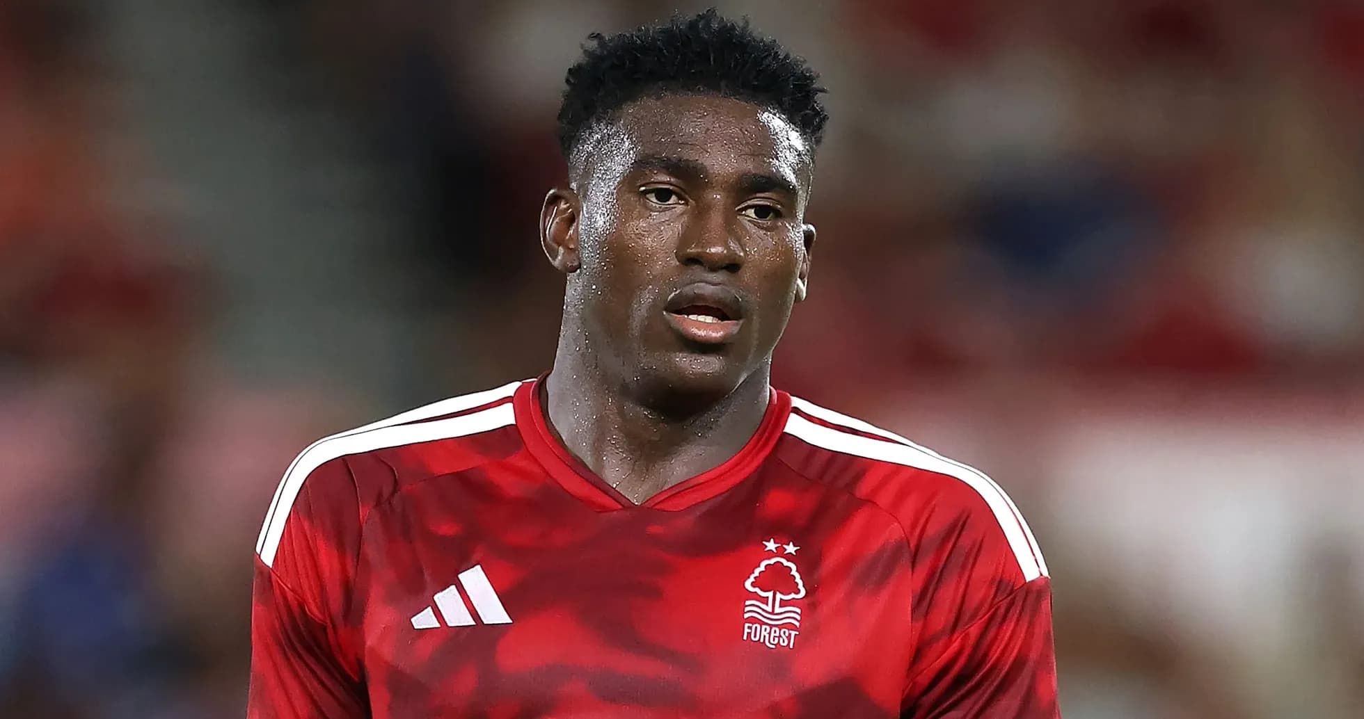 Player wearing red Nottingham Forest jersey on field Player wearing red Nottingham Forest jersey on field