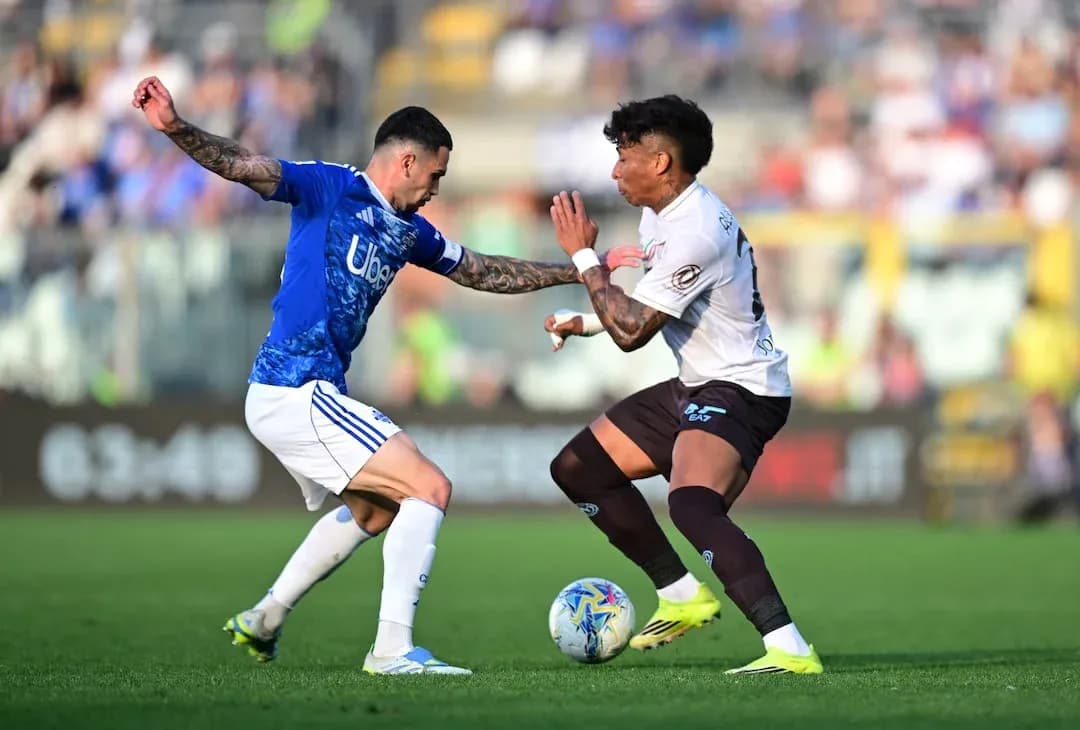Player tackling opponent during Napoli vs Como match Player tackling opponent during Napoli vs Como match