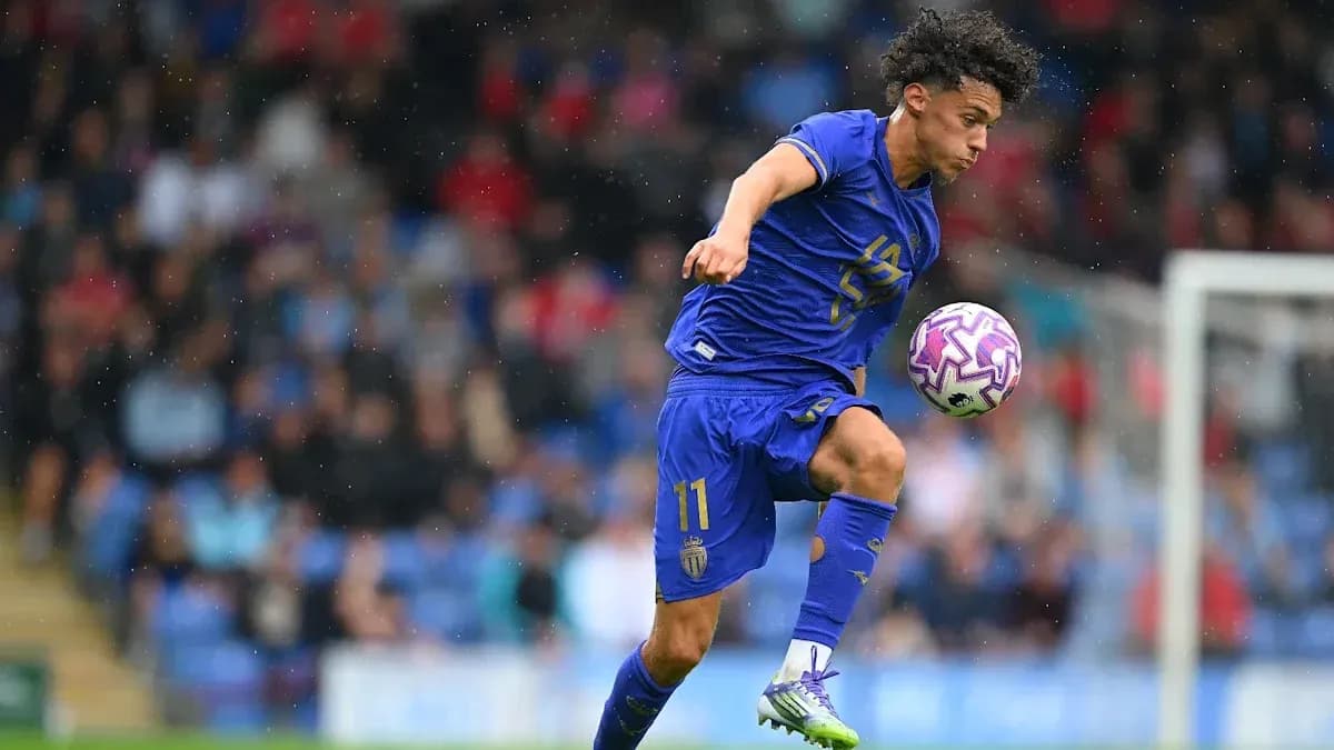 Player in blue kit controlling ball during match Player in blue kit controlling ball during match