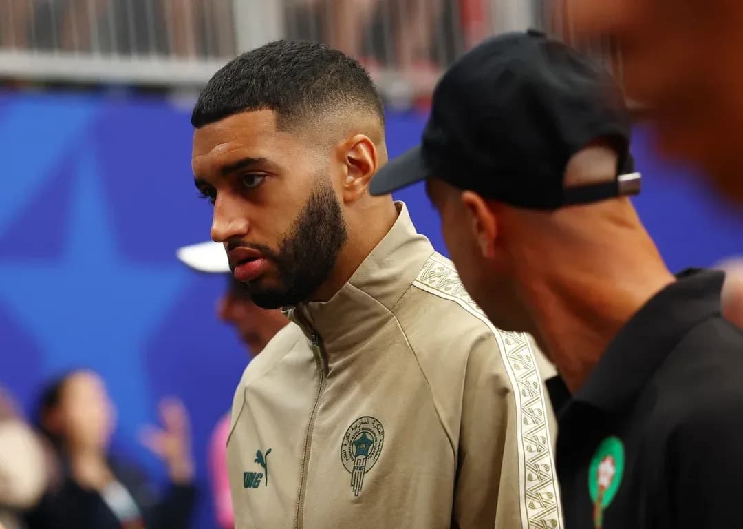 Player in Morocco team jacket interacting with others Player in Morocco team jacket interacting with others