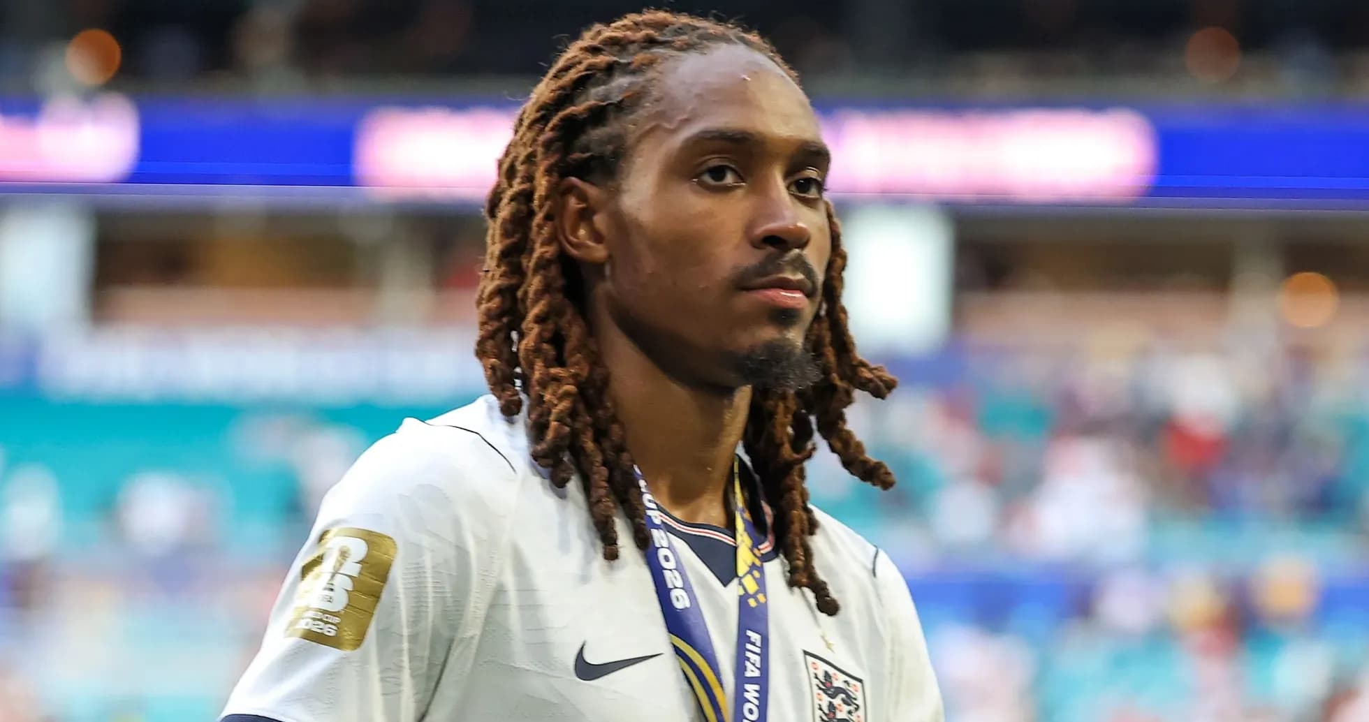 Player wearing England jersey with medal around neck Player wearing England jersey with medal around neck