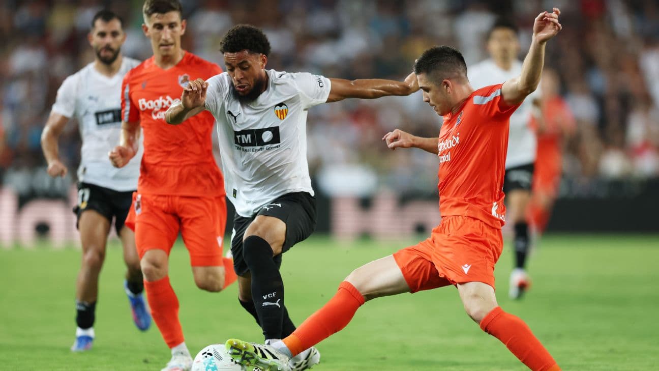 Real Sociedad players challenging Valencia in La Liga match Real Sociedad players challenging Valencia in La Liga match
