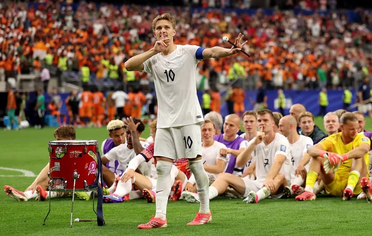 Player gesturing to crowd with teammates seated behind Player gesturing to crowd with teammates seated behind
