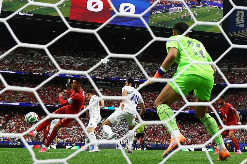 Goalkeeper preparing to block a shot during match Goalkeeper preparing to block a shot during match