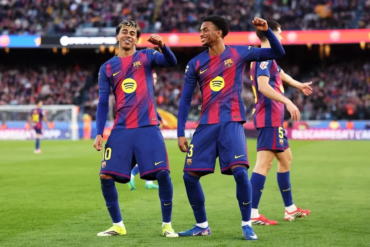 Two FC Barcelona players celebrating on the field Two FC Barcelona players celebrating on the field