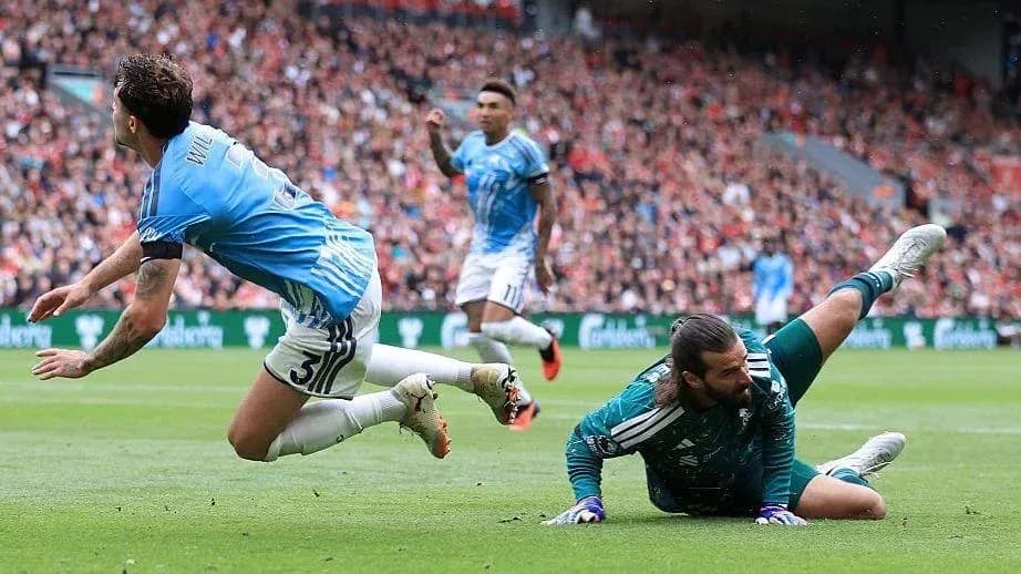 Goalkeeper making a save as player falls Goalkeeper making a save as player falls