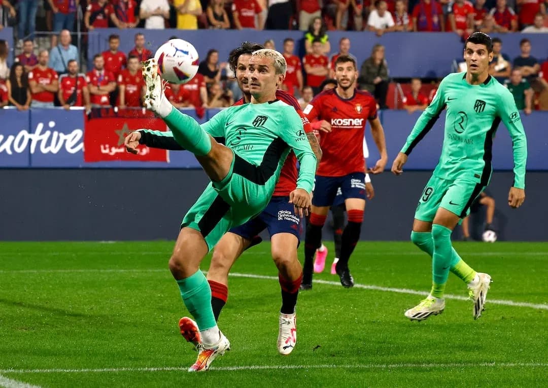 Atletico Madrid player attempting a kick Atletico Madrid player attempting a kick