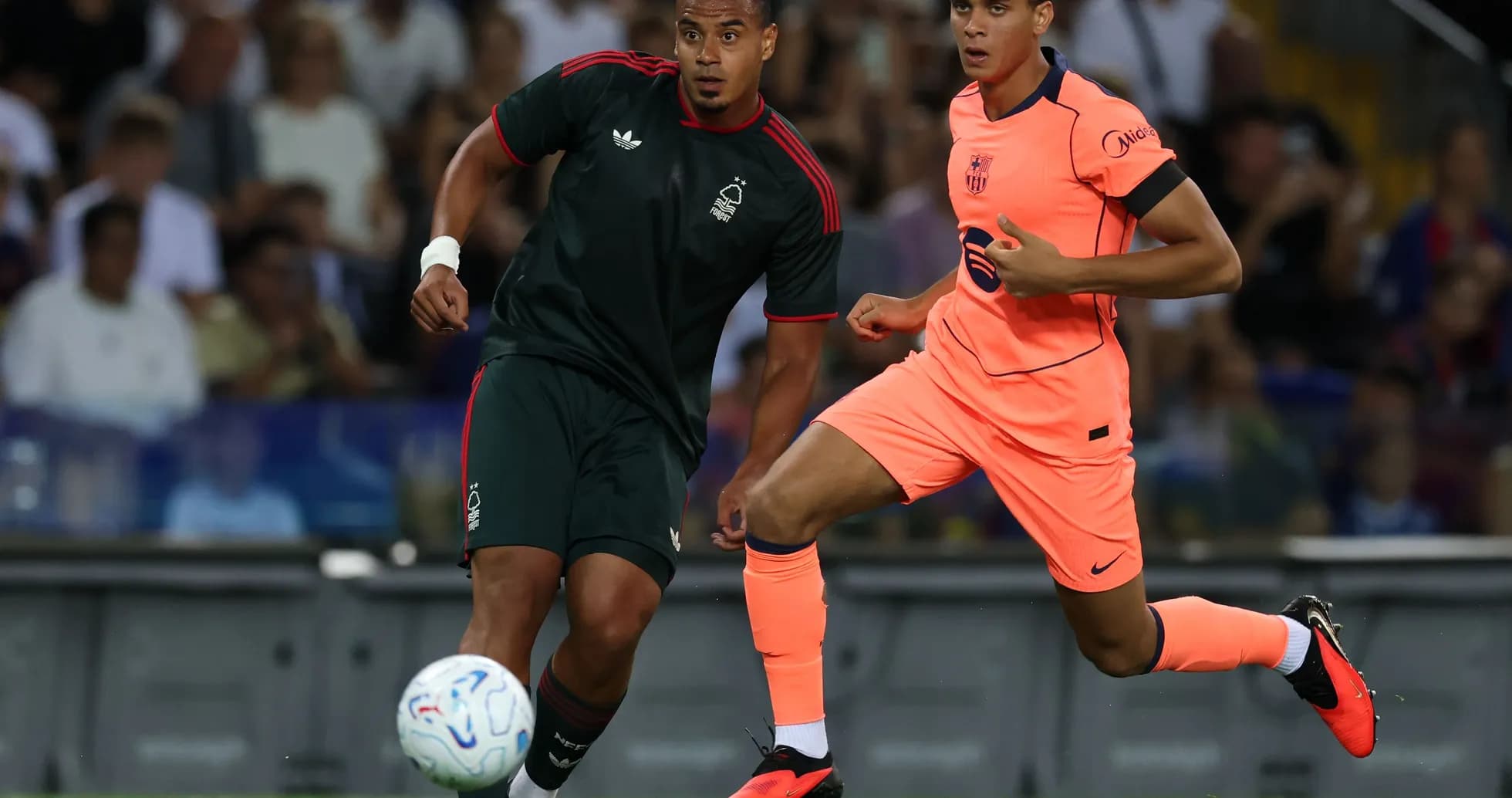 Two players competing for the ball on field Two players competing for the ball on field