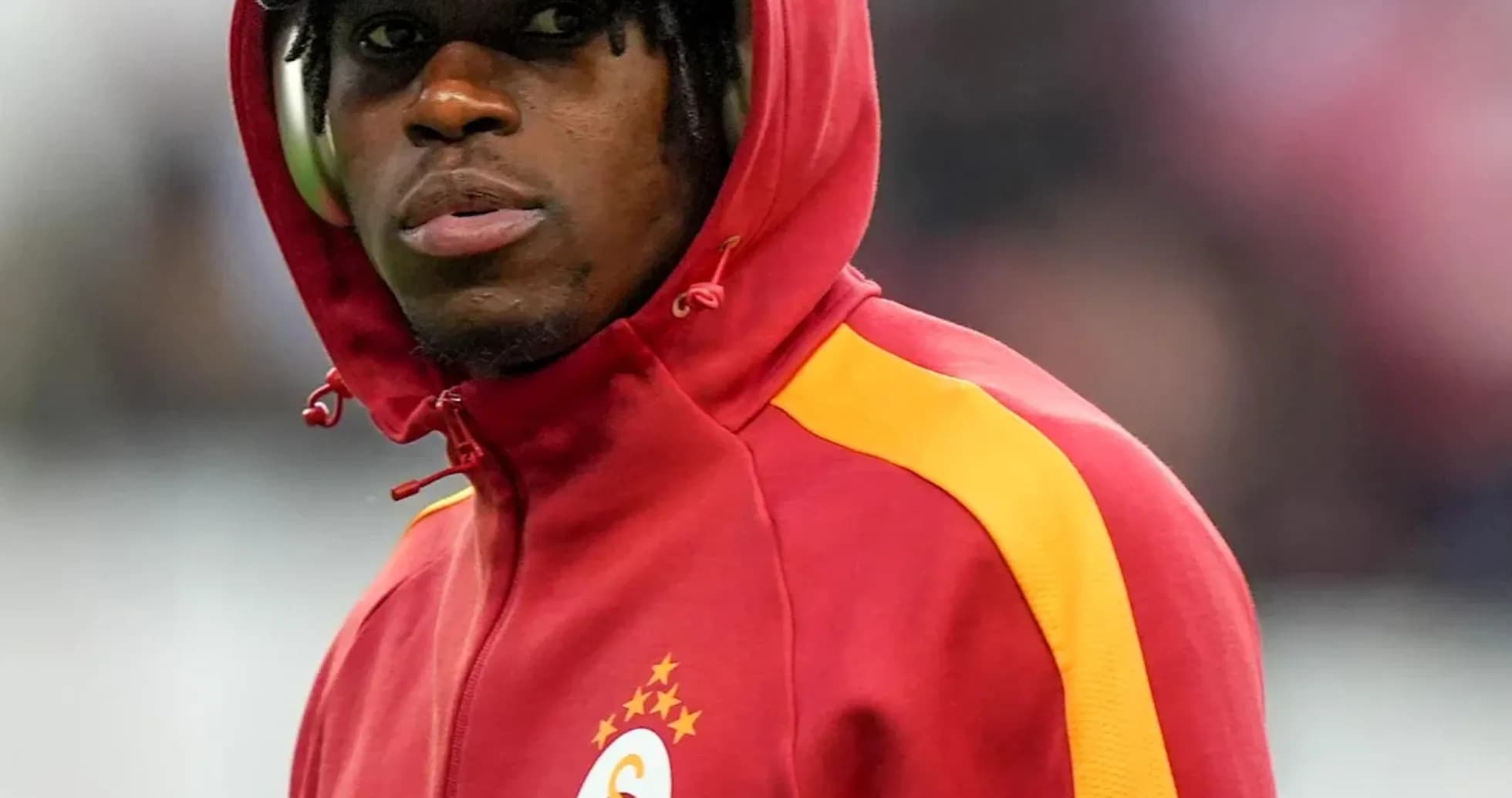 Player wearing a red hoodie with club logo Player wearing a red hoodie with club logo
