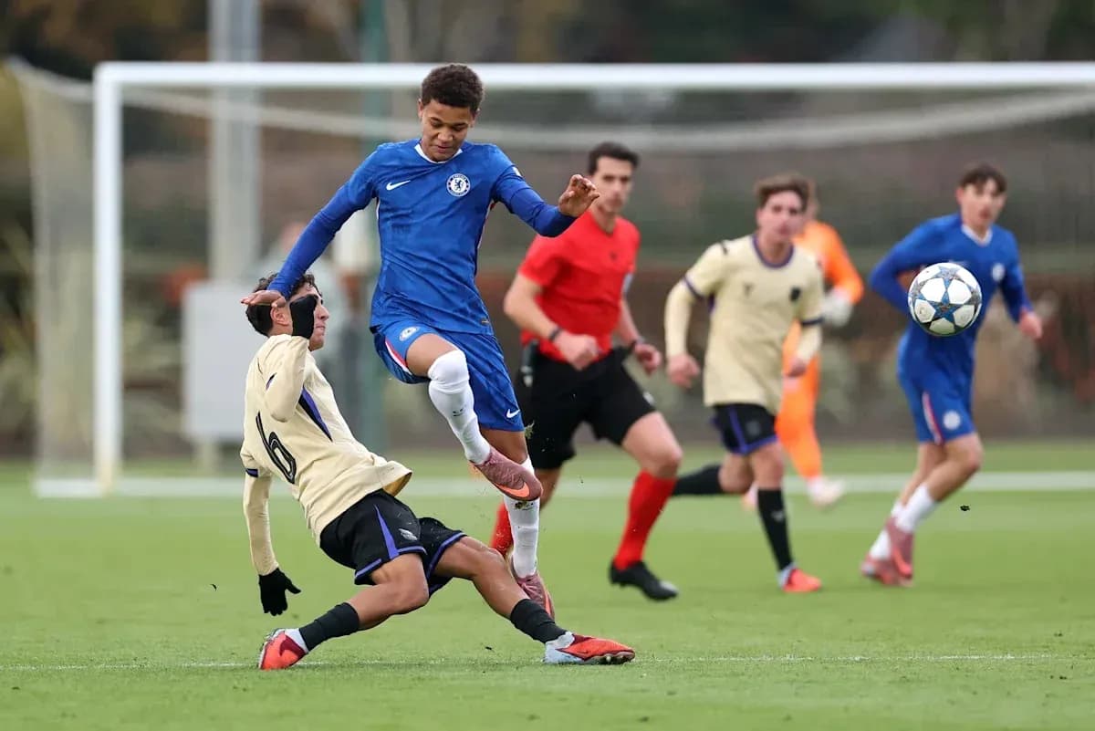 Player in blue jumping over opponent on field Player in blue jumping over opponent on field
