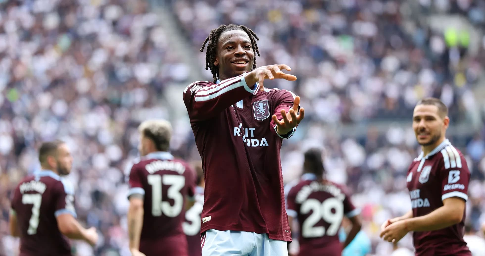 Player celebrating with teammates on the pitch Player celebrating with teammates on the pitch