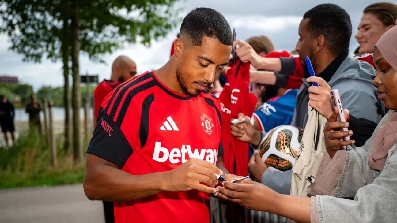 Player signing autographs for fans at event Player signing autographs for fans at event