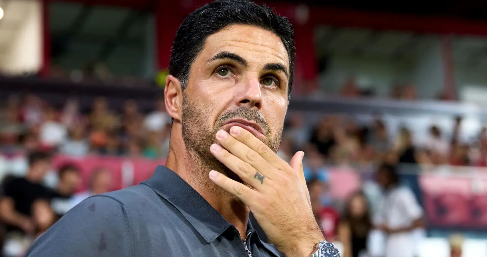 Coach observing match with thoughtful expression Coach observing match with thoughtful expression