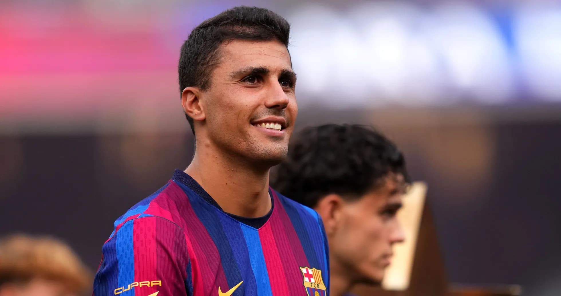 Football player smiling during trophy celebration event Football player smiling during trophy celebration event
