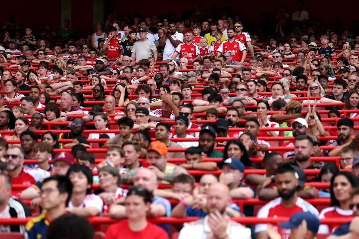 Crowd of fans in Arsenal jerseys at stadium Crowd of fans in Arsenal jerseys at stadium