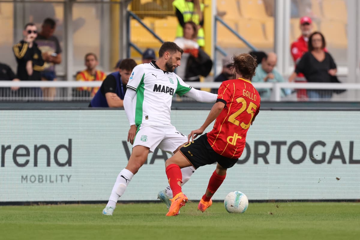 Sassuolo player challenging Lecce player for the ball Sassuolo player challenging Lecce player for the ball