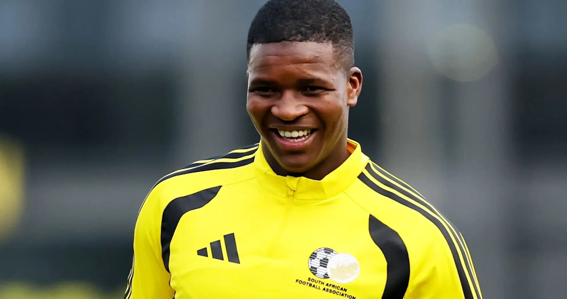 Player smiling in yellow training jersey Player smiling in yellow training jersey