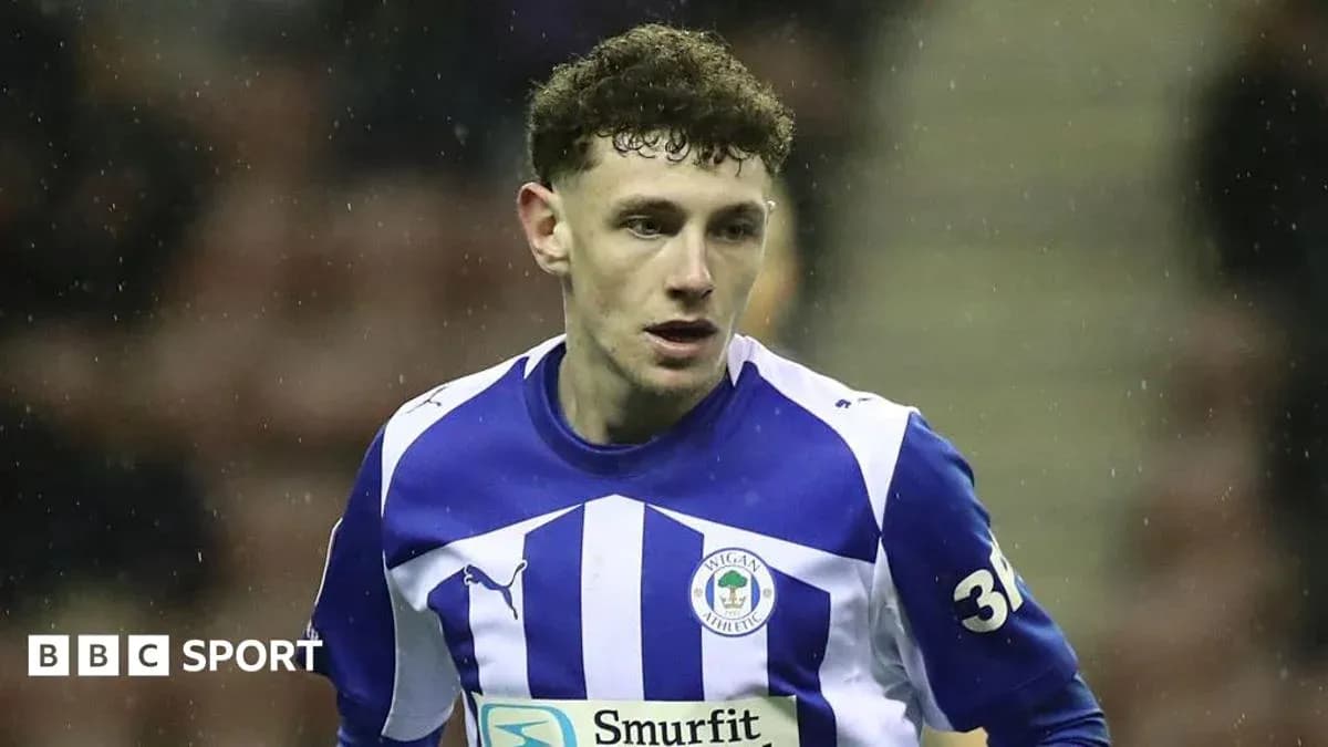 Player in Wigan Athletic kit during match action Player in Wigan Athletic kit during match action