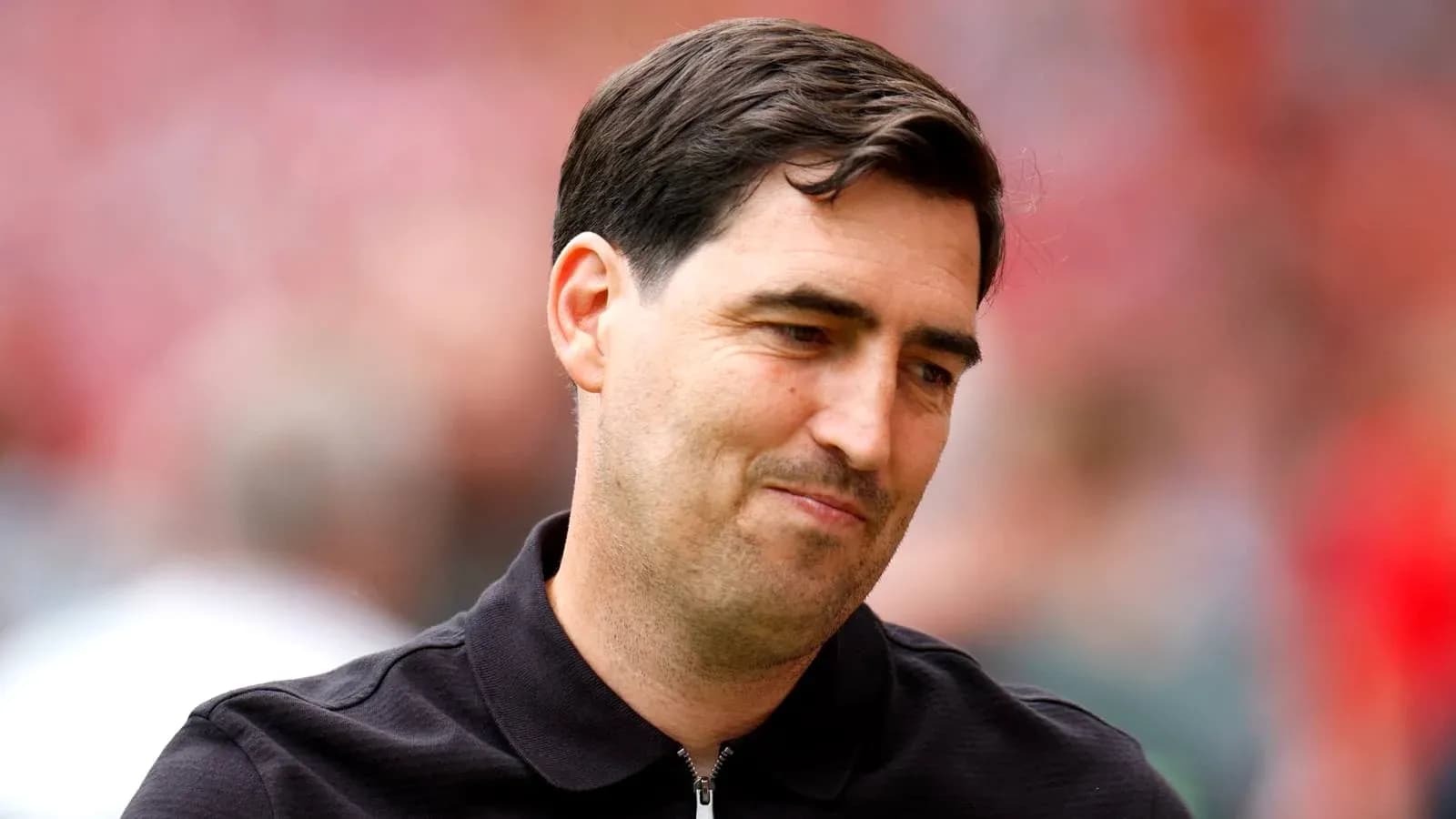 Coach during match, wearing black jacket Coach during match, wearing black jacket