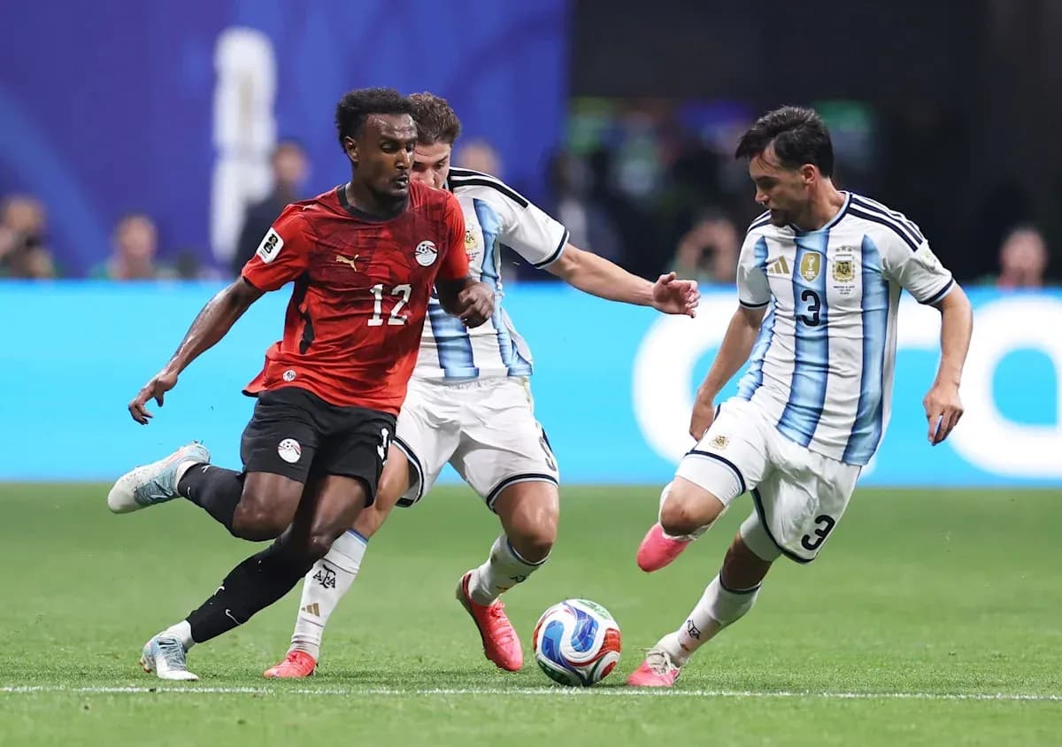 Egyptian player dribbling past Argentinian defenders Egyptian player dribbling past Argentinian defenders