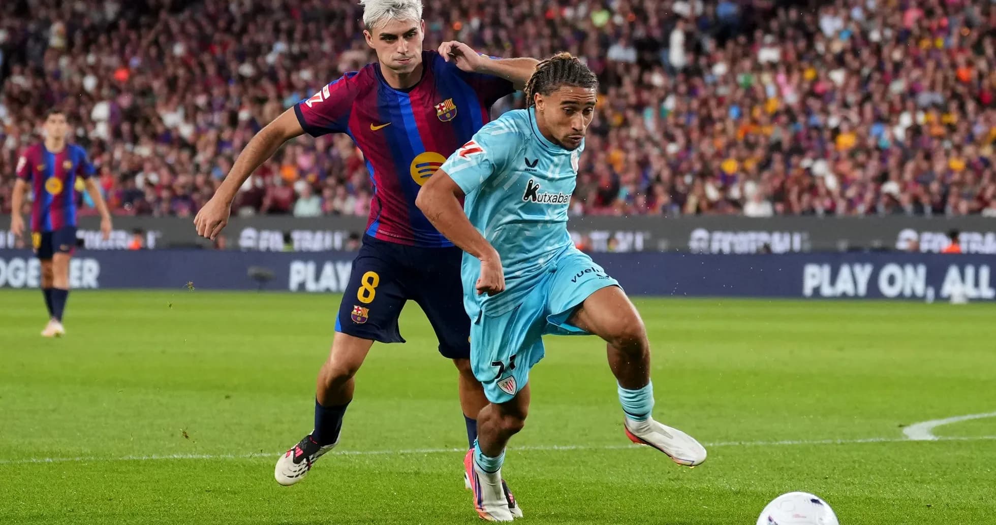 Player from Barcelona tackles opponent during match Player from Barcelona tackles opponent during match