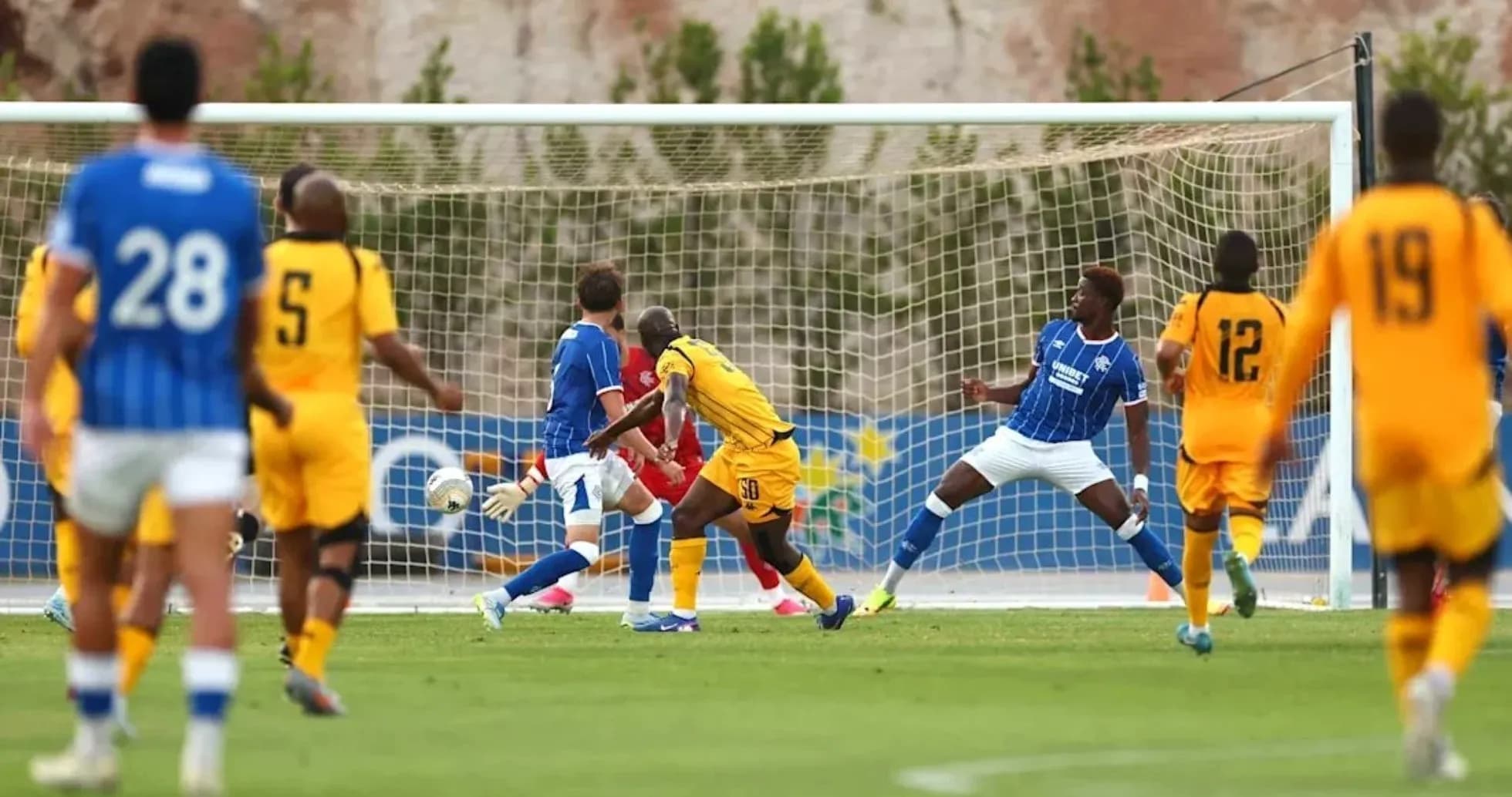 Players competing near the goal during football match Players competing near the goal during football match