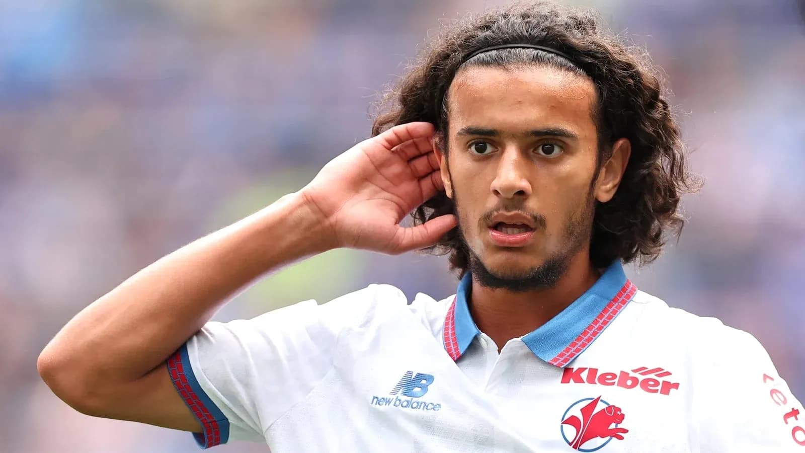 Player gesturing during a football match Player gesturing during a football match