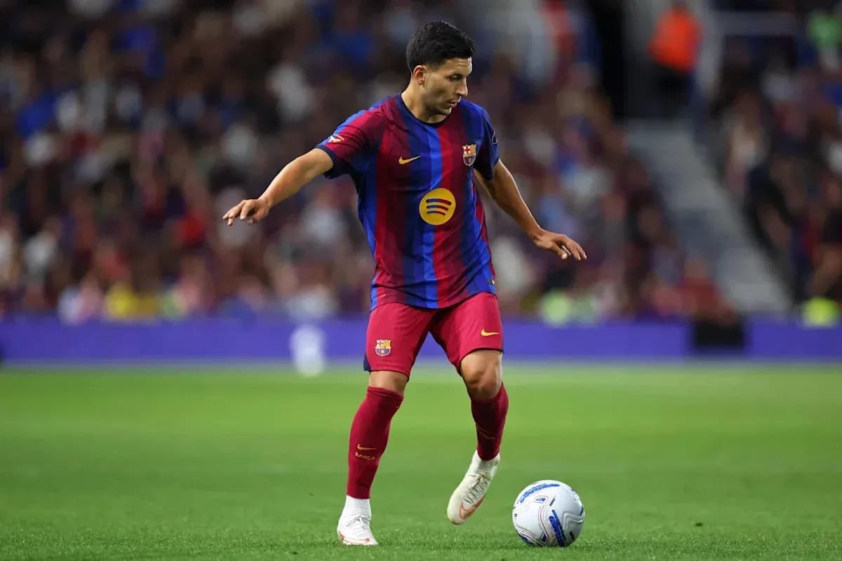 Barcelona player dribbling the ball on the field Barcelona player dribbling the ball on the field