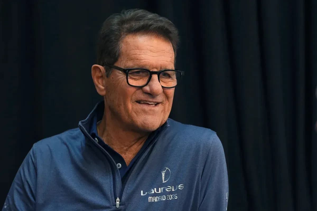 Man in blue jacket smiling during event Man in blue jacket smiling during event
