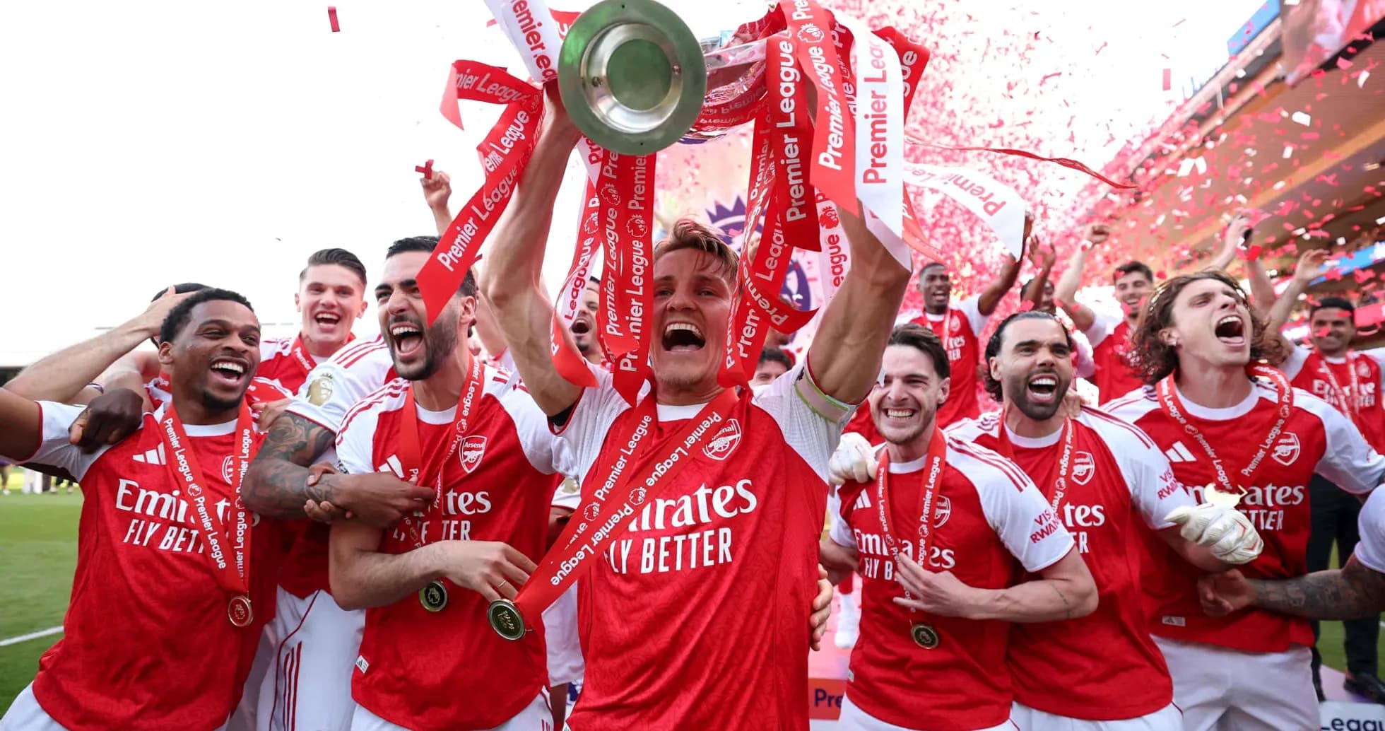 Arsenal players celebrating with Premier League trophy Arsenal players celebrating with Premier League trophy