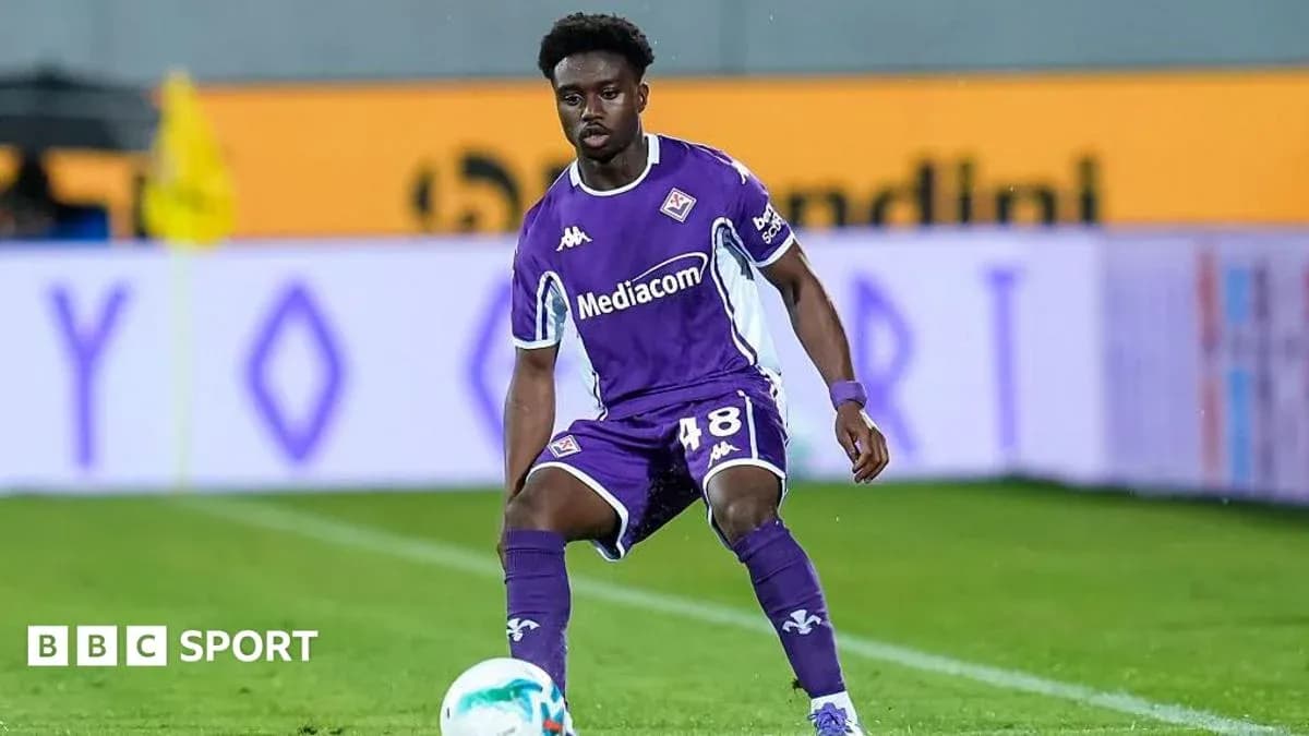 Player in purple kit preparing to pass the ball Player in purple kit preparing to pass the ball