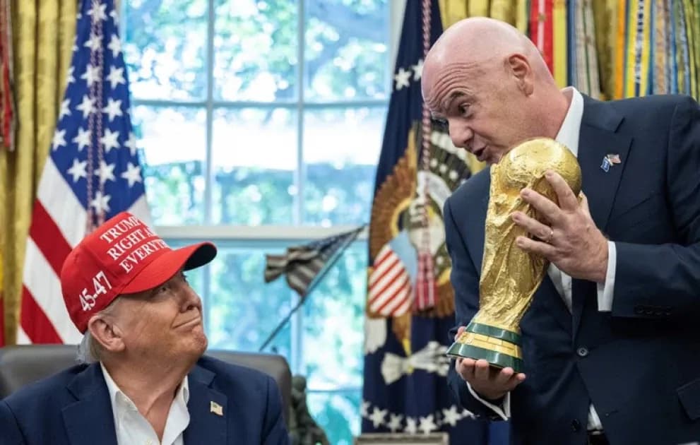Man holding FIFA World Cup trophy with another man Man holding FIFA World Cup trophy with another man