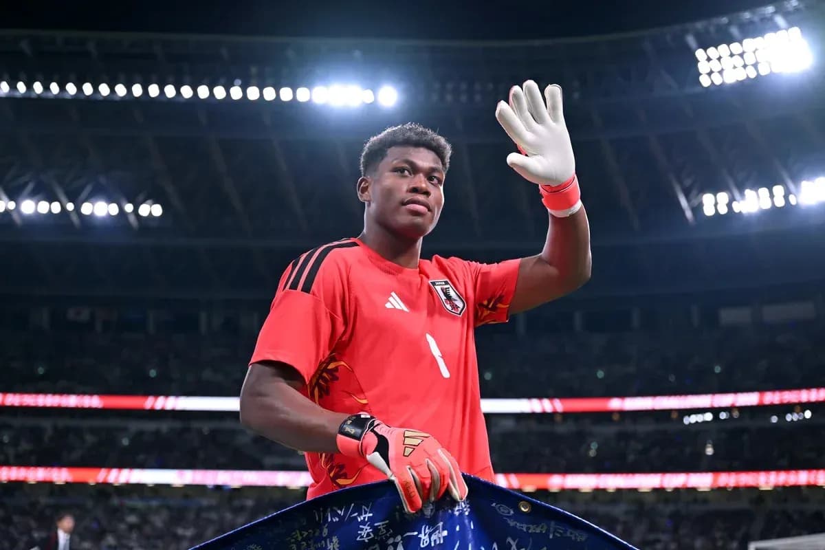 Goalkeeper waving while holding a team banner Goalkeeper waving while holding a team banner