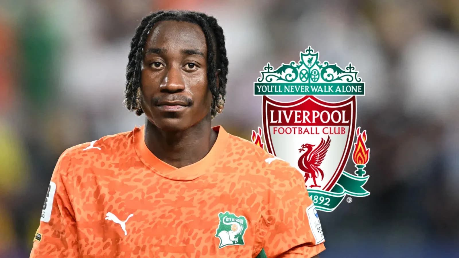 Goalkeeper wearing orange jersey with Liverpool logo Goalkeeper wearing orange jersey with Liverpool logo