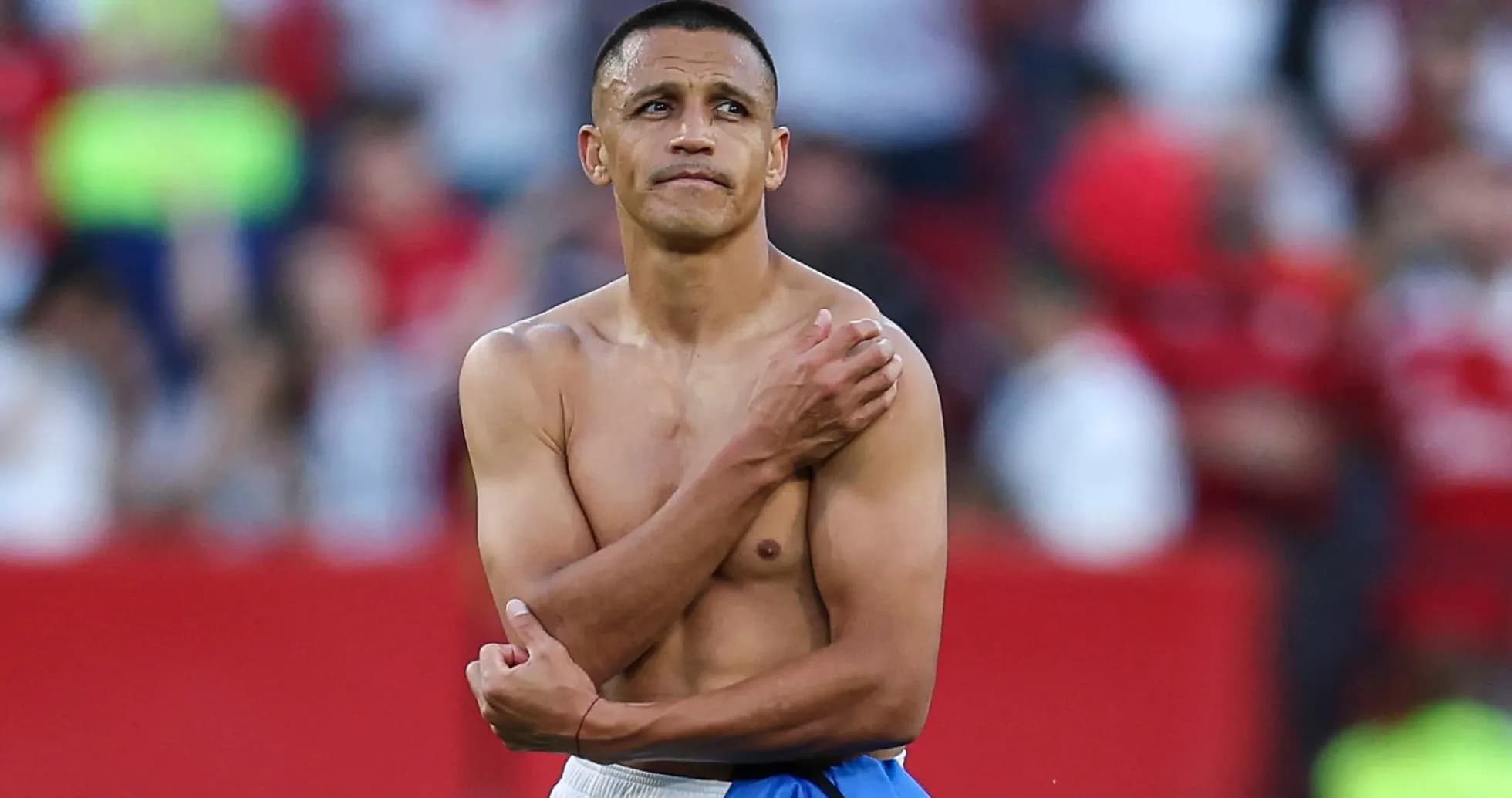 Player with no shirt looking around in stadium Player with no shirt looking around in stadium